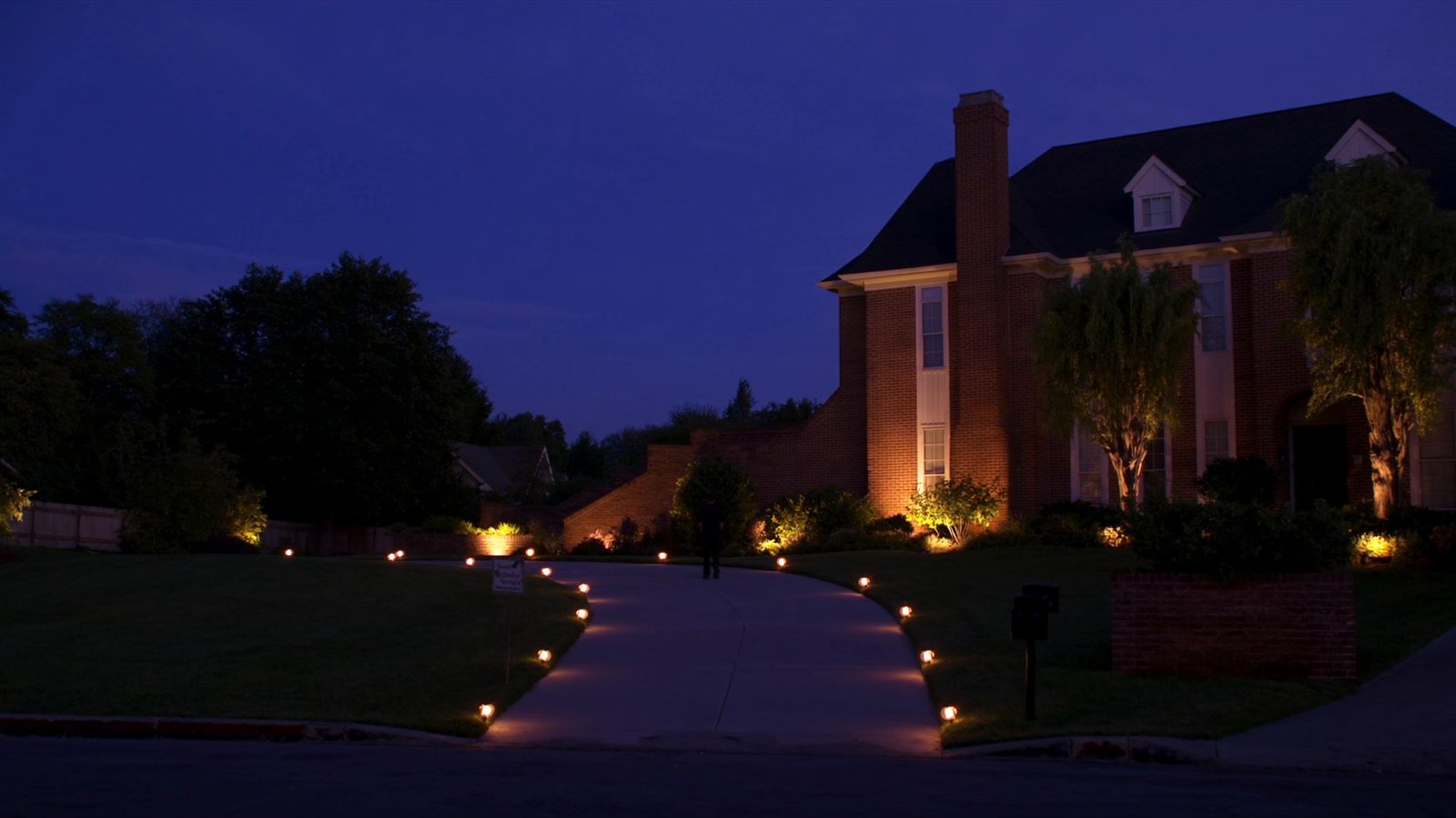 Landscape lighting installation at dusk along a walkway in Greensboro NC